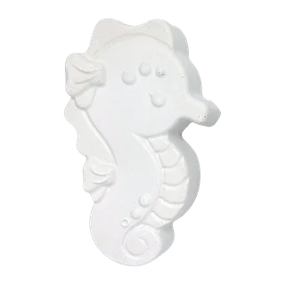 The seahorse casting, unpainted white plaster: a seahorse in profile with a curled tail and a ridged snout.